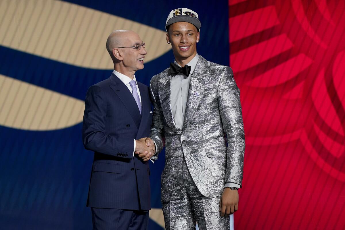 Dyson Daniels, right, is congratulated by NBA Commissioner Adam Silver after being selected eighth overall by the New Orleans Pelicans in the NBA basketball draft, Thursday, June 23, 2022, in New York. (AP Photo/John Minchillo)