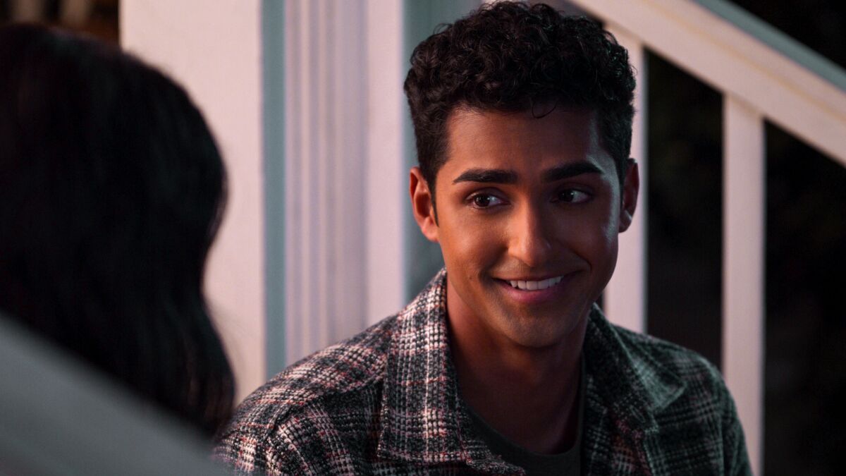 A young man smiles in a scene from the Netflix teen dramedy "Never Have I Ever"