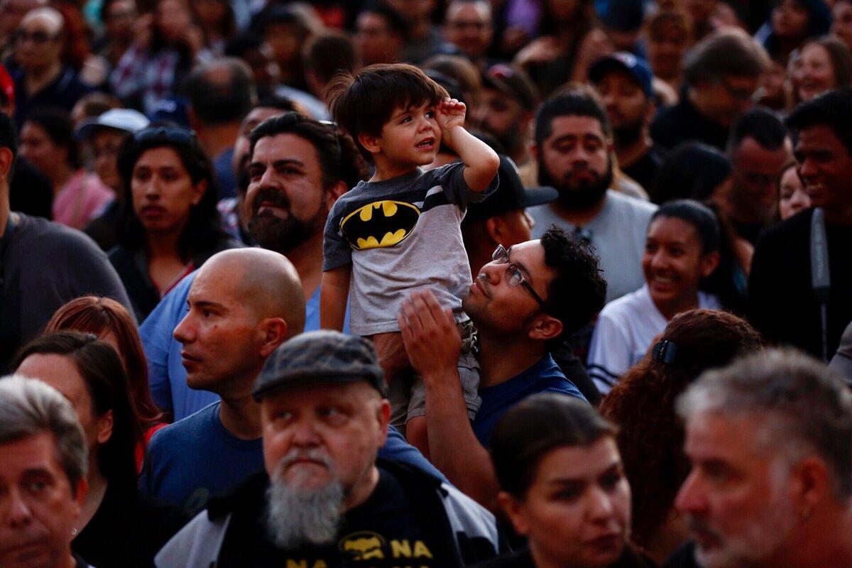 Artemio Rangel, 34, and son Roan wait for the Bat signal during a tribute to Adam West at L.A. City Hall on June 15.