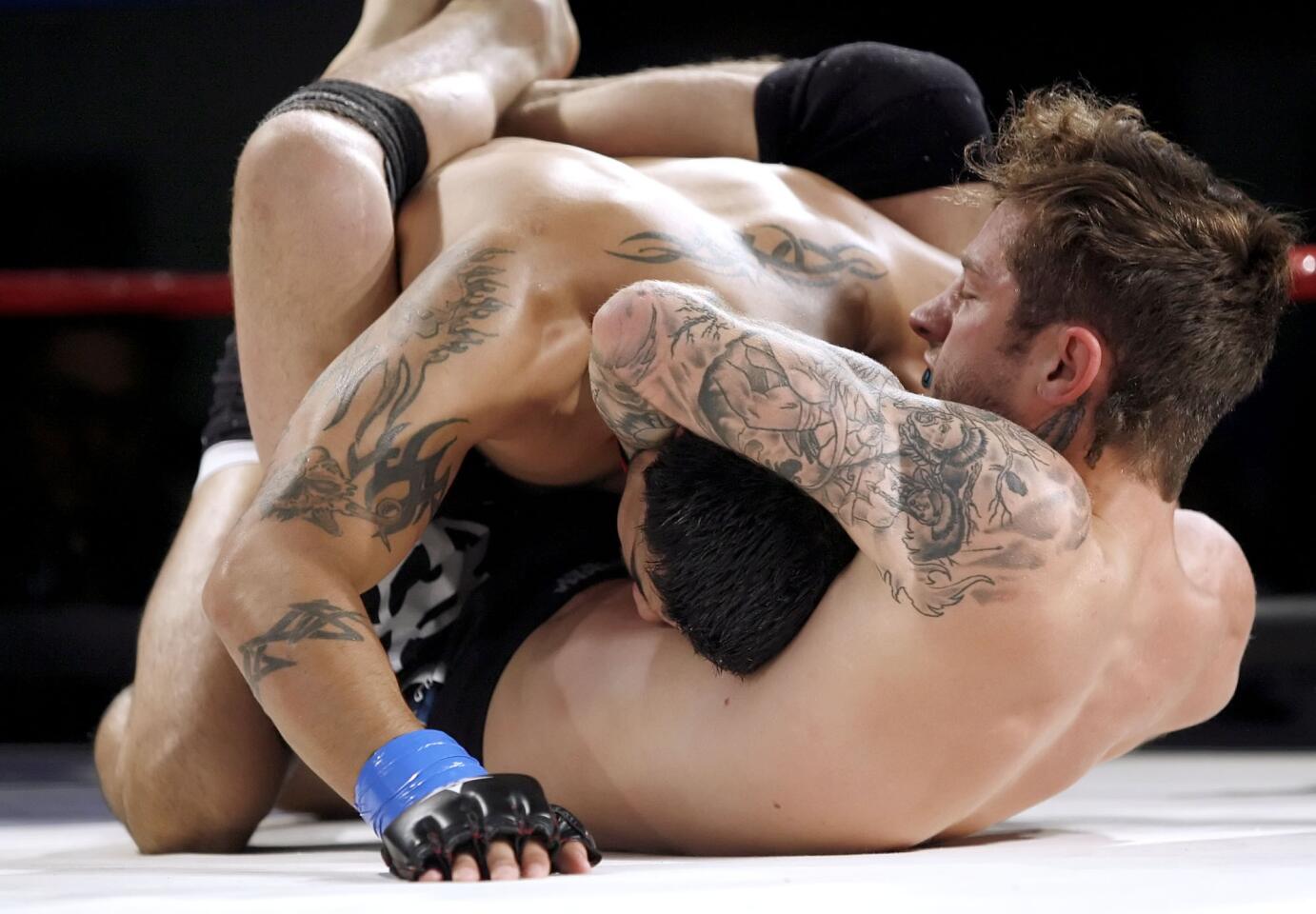 MMA fighter Chris Bradley, right, chokes his opponent Bobby Sanchez, left, into submission during the Chaos at the Casino Event at Hollywood Park Casino in Inglewood on Saturday, May 5, 2012.