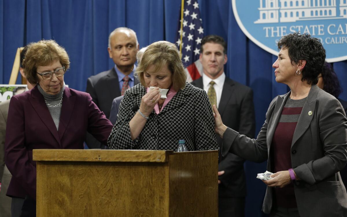 Debbie Ziegler, center, the mother of Brittany Maynard, is comforted by state Sen. Lois Wolk (D-Davis), left, and Assemblymember Susan Talamantes Eggman (D-Stockton) as she appeared in January in support of proposed legislation allowing doctors to prescribe life-ending medication to terminally ill patients. Maynard, a 29-year-old San Francisco Bay Area woman who had terminal brain cancer, ended her own life.