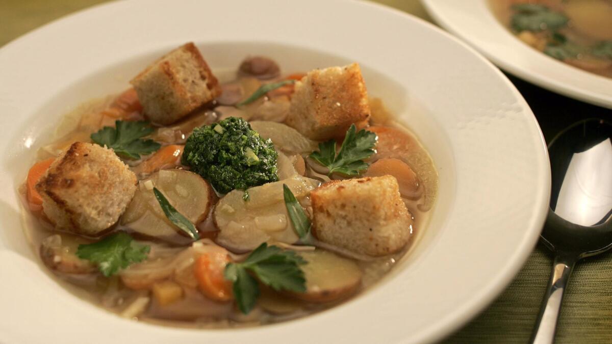 Rustic vegetable soup with rye croutons and parsley-savory "pistou."