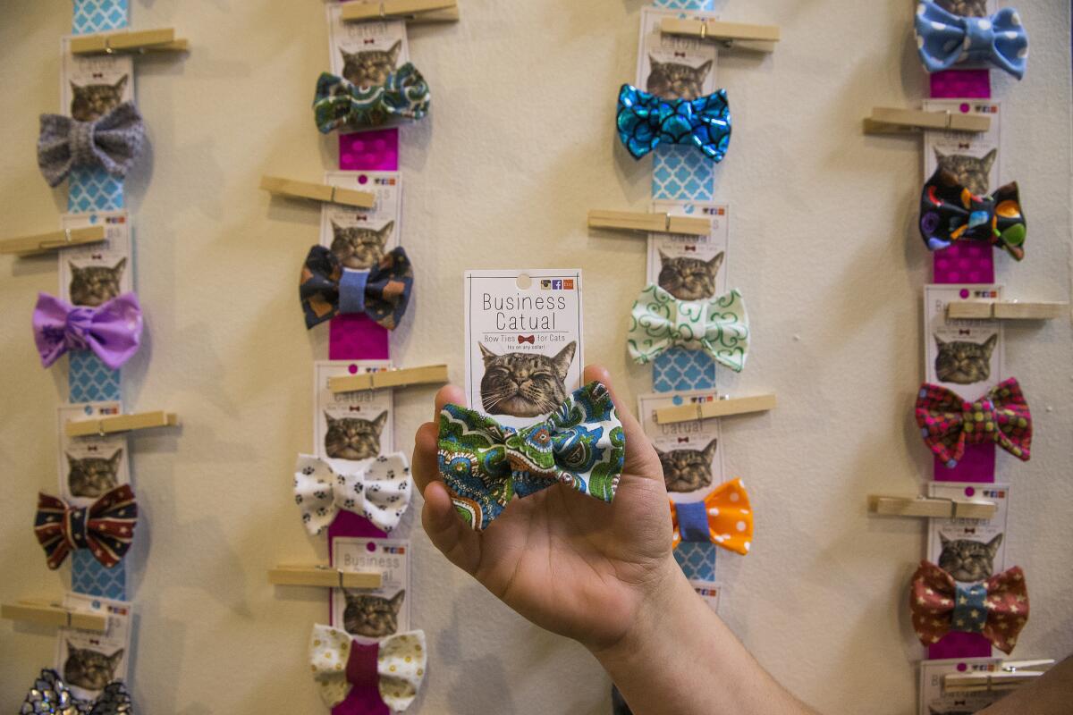 Becca Priddy holds one of her Business Catual bow ties for cats at CatConLA on June 6.
