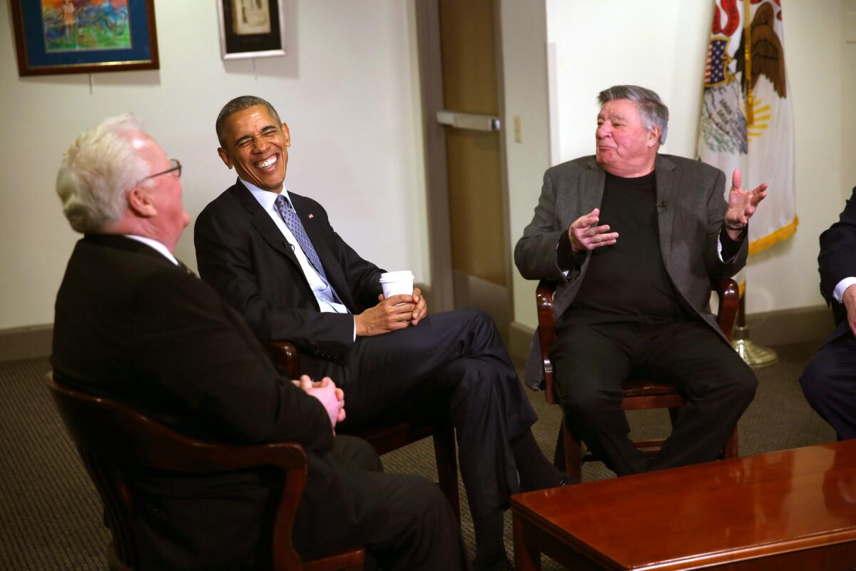 President Obama laughs with former colleagues from the Illinois General Assembly, including former senators Larry Walsh, left, and Denny Jacobs, right, Feb. 10, 2016 in Springfield.
