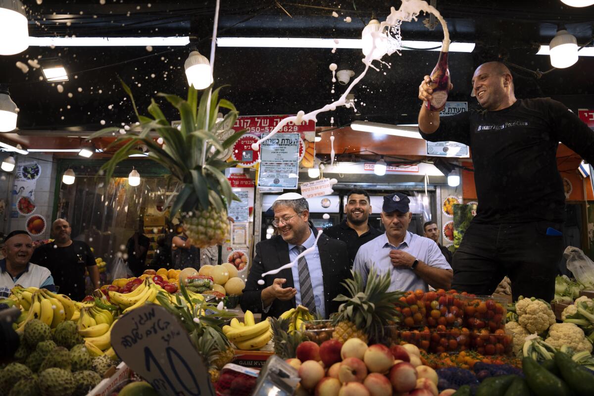 Israeli politician and his supporters visit at a Tel Aviv market