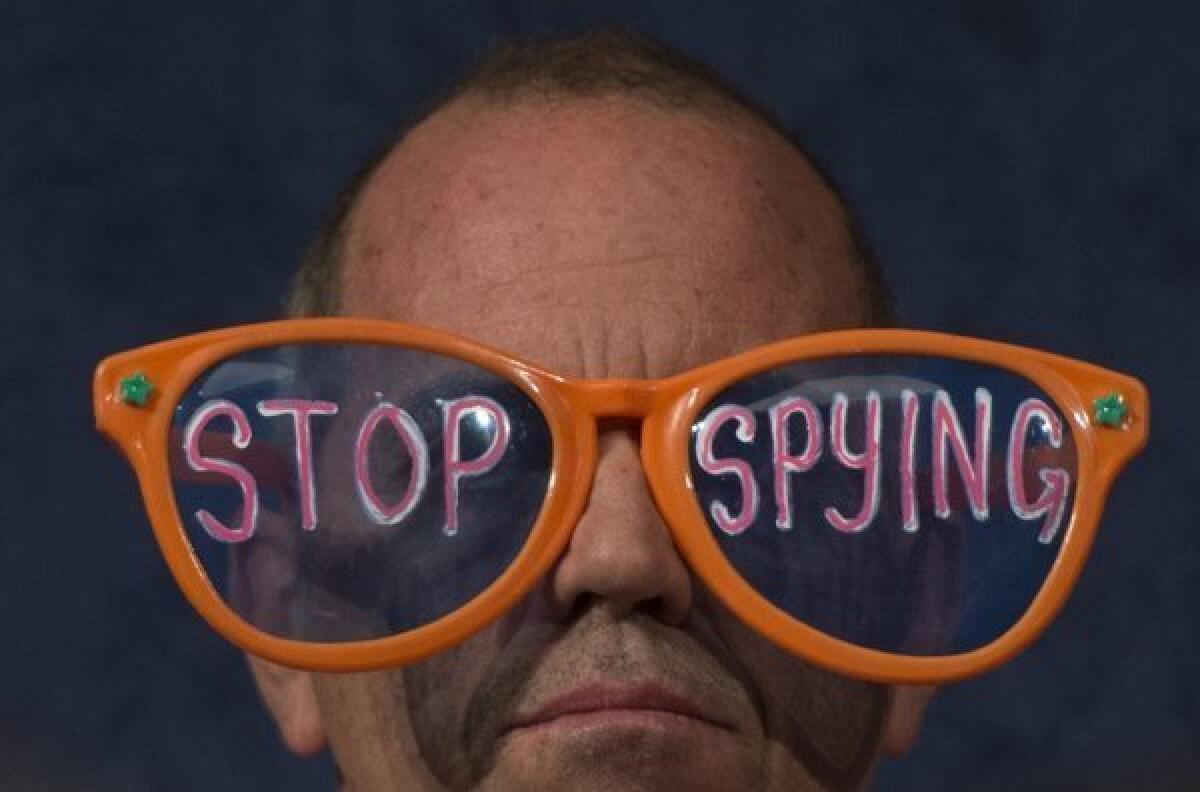 A protester with the organization Code Pink looks on as the directors of national intelligence and the National Security Agency testify before the House Select Intelligence Committee in October.