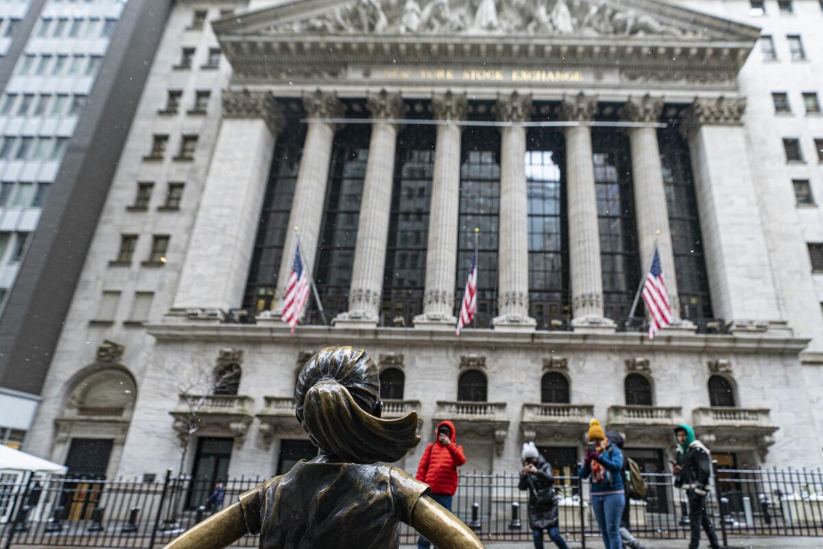 The Fearless Girl statue stands outside of the New York Stock Exchange building. 