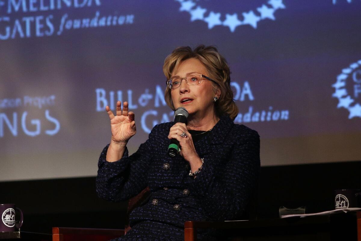 Former Secretary of State Hillary Rodham Clinton takes part in a New York University discussion about the status of women. She was joined by her daughter, Chelsea, and philanthropist Melinda Gates, wife of Microsoft co-founder Bill Gates.