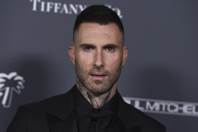 Adam Levine looks directly at the camera
