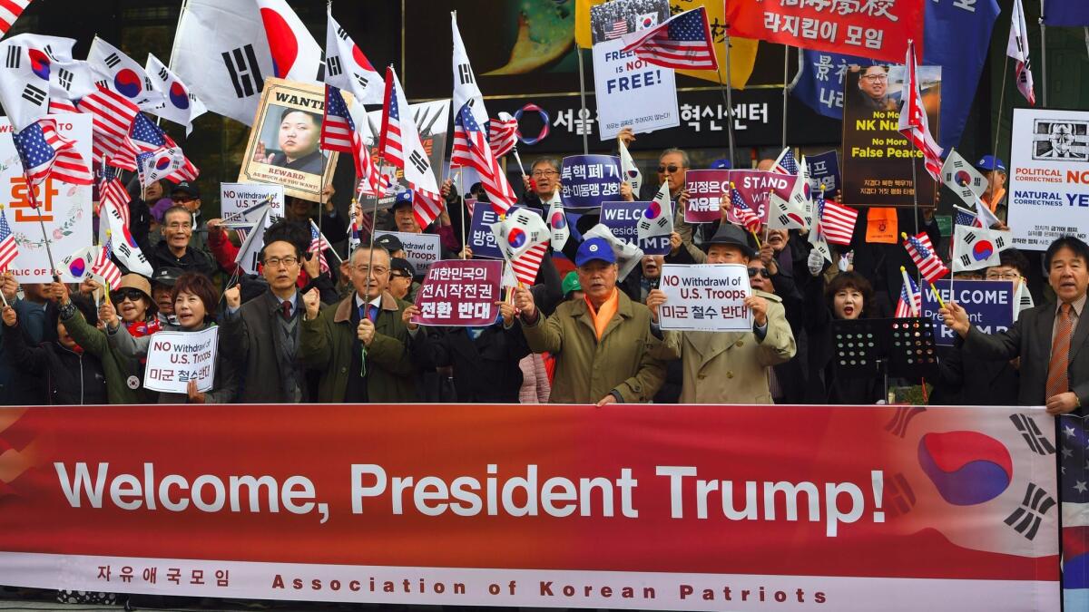 South Korean conservative activists hold signs reading, "Welcome President Trump," during a pro-U.S. rally near the U.S. Embassy in Seoul on Nov. 6, 2017, ahead of Trump's visit.