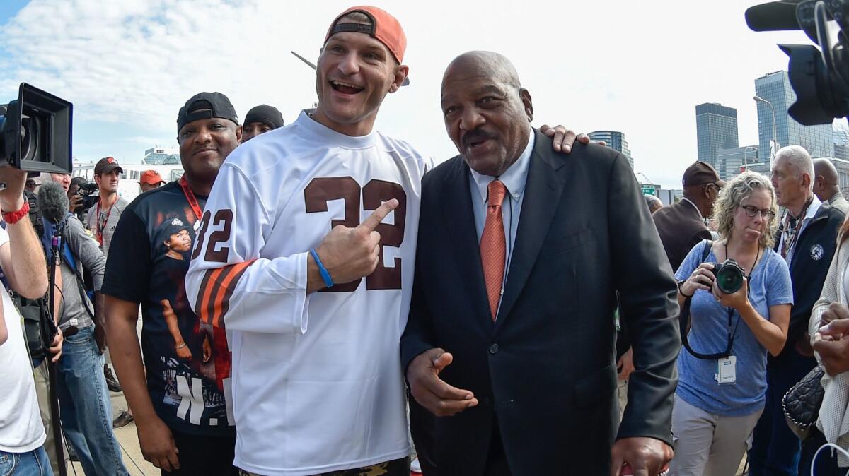 Stipe Miocic poses with Pro Football Hall of Famer Jim Brown before a Cleveland Browns game last September.