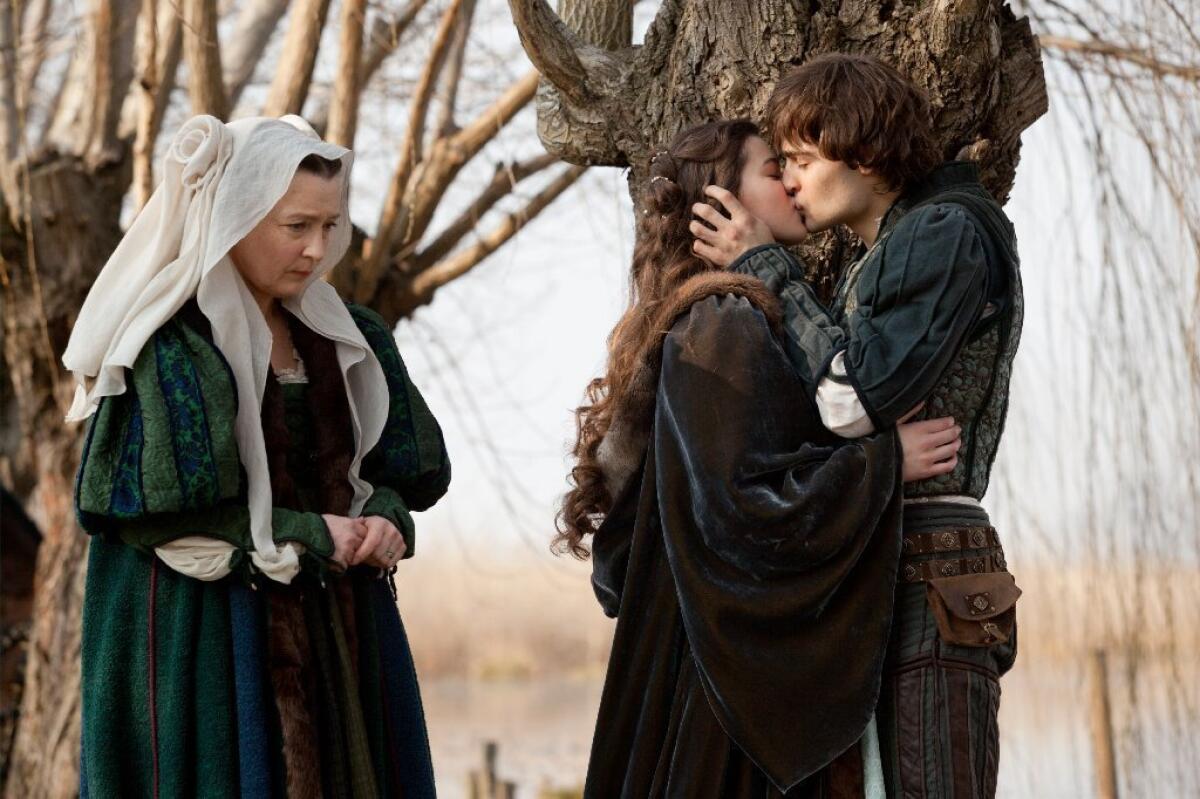 Douglas Booth, right, and Hailee Steinfeld, center, in a scene from "Romeo and Juliet."