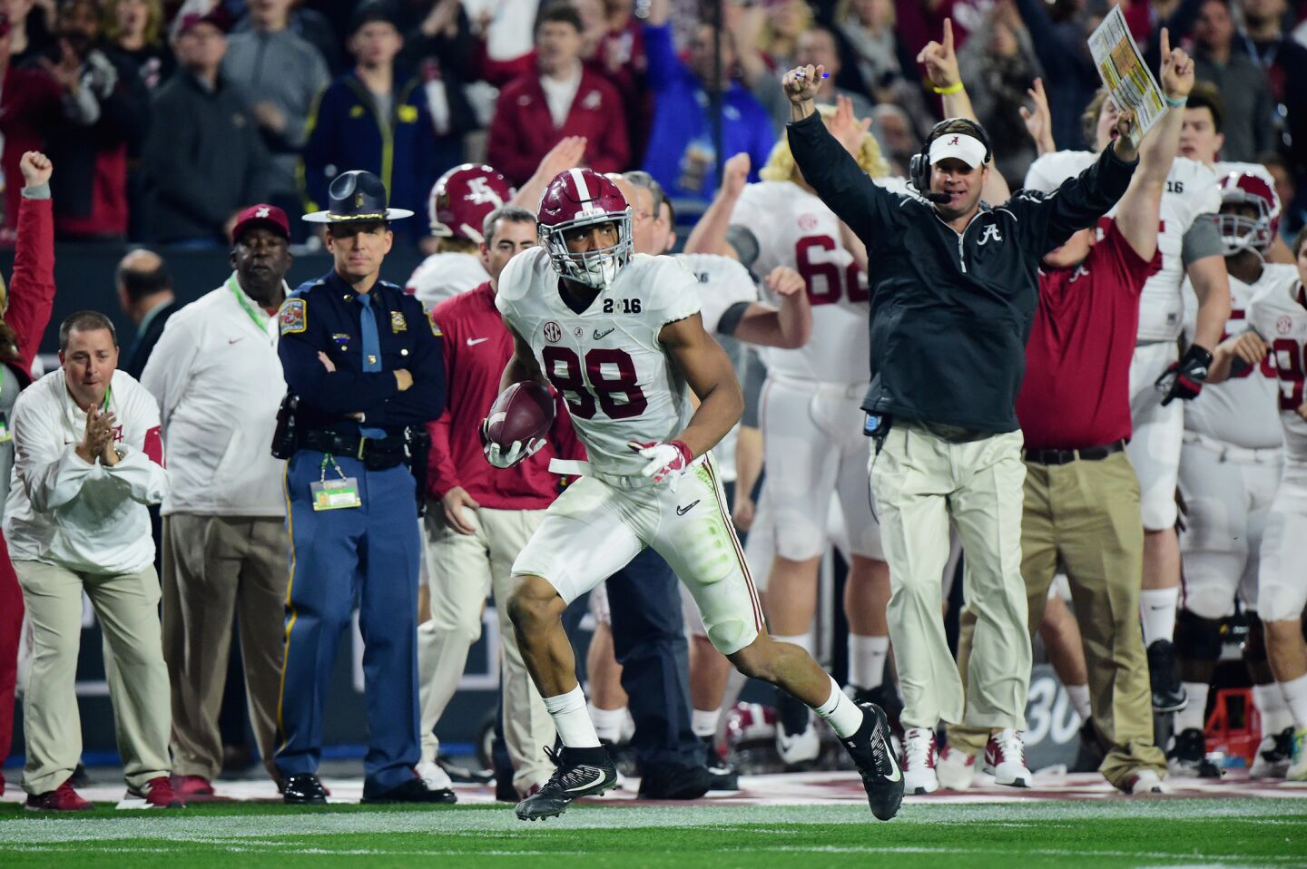 Alabama tight end O.J. Howard catches a 53-yard touchdown in the third quarter as offensive coordinator Lane Kiffin celebrates.
