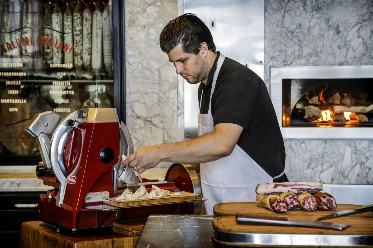 Chef Chad Colby slicing meats for an Affettati Misti plate at Chi Spacca.
