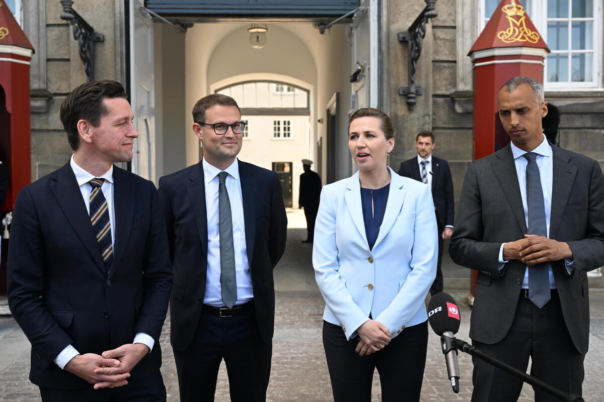 Danish Prime Minister Mette Frederiksen, second from right, presents Mattias Tesfaye as new Minister of Justice, right, Kaare Dybvad Bek as new Minister of Foreign Affairs and Integration, left, and member of Parliament Christian Rabjerg Madsen as new Minister of Interior and Housing, second from left, at at Amalienborg Castle in Copenhagen, Monday, May 2, 2022. Denmark announced a Cabinet reshuffle on Monday after Justice Minister Nick Haekkerup resigned to become the new head of the Danish Brewers' Association. (Philip Davali/Ritzau Scanpix via AP)