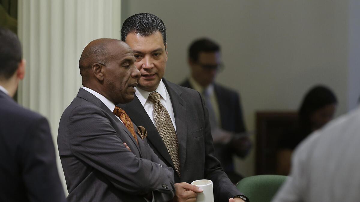 State Sen. Steven Bradford, left, shown talking to Secretary of State Alex Padilla, won a change to sentencing laws Wednesday.