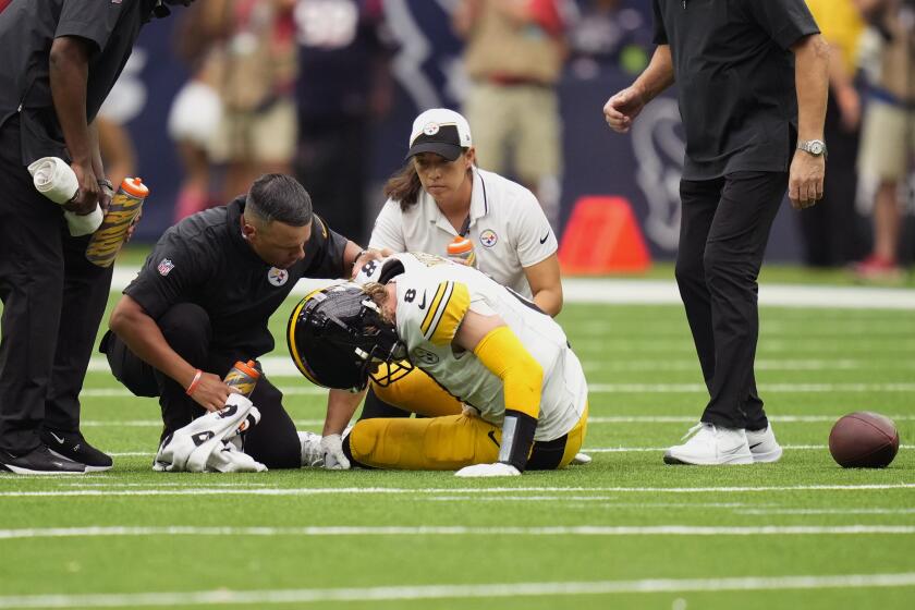 Pittsburgh Steelers quarterback Kenny Pickett (8) is helped after an injury during the second half of an NFL football game against the Houston Texans, Sunday, Oct. 1, 2023, in Houston. (AP Photo/David J. Phillip)