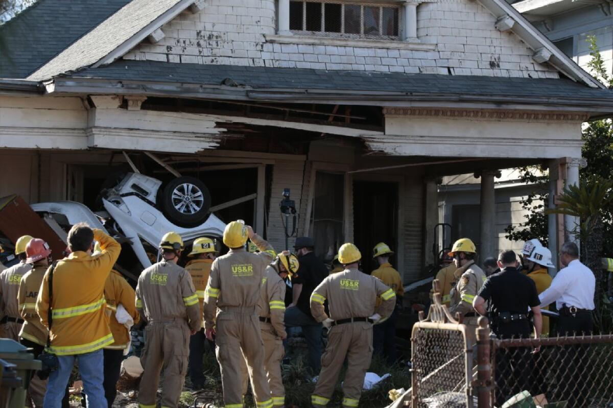 A vehicle crashed into an unoccupied home on Pleasant Avenue in Boyle Heights on Sunday after its occupants were shot at. Two people were dead and another injured after the attack and crash.