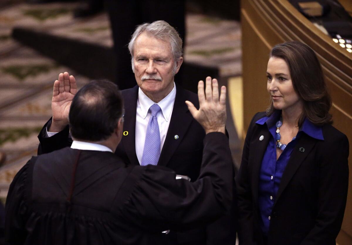 Oregon Gov. John Kitzhaber and his fiancee, Cylvia Hayes, seen at his swearing-in earlier this year, are the focus of multiple investigations.
