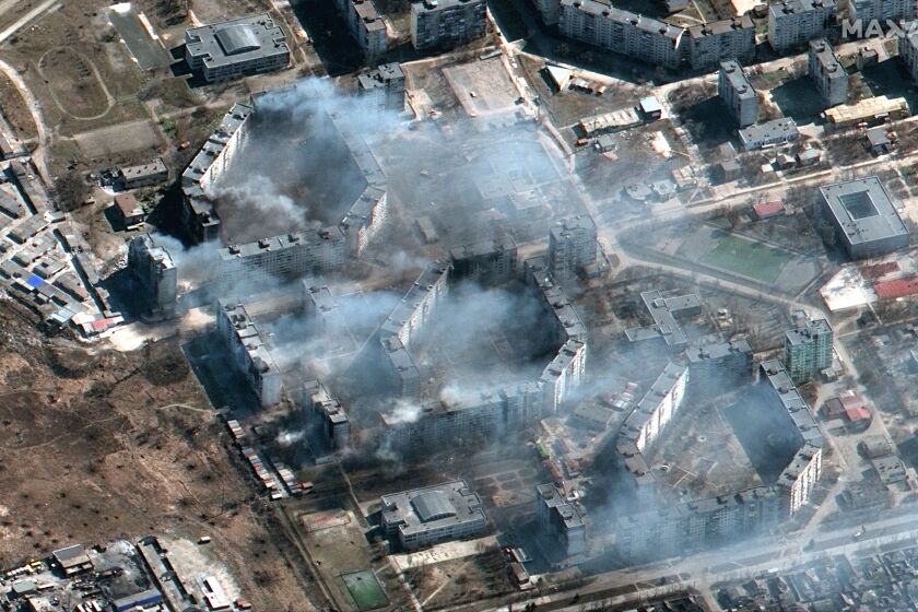 This satellite image provided by Maxar Technologies shows burning apartment building in northeastern Mariupol, Ukraine during the Russian invasion on Saturday, March 19, 2022. (Satellite image ©2022 Maxar Technologies via AP)