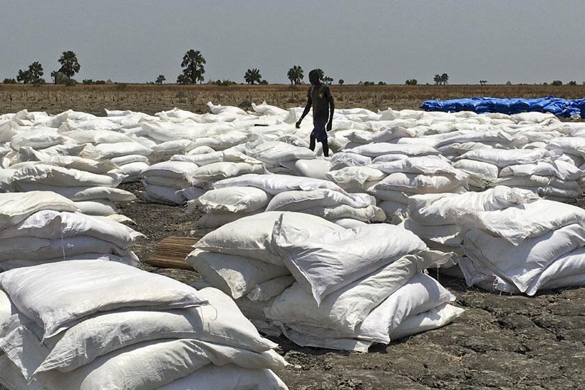 Bags of food dropped by air from a World Food Program plane are sorted in Padeah, South Sudan.