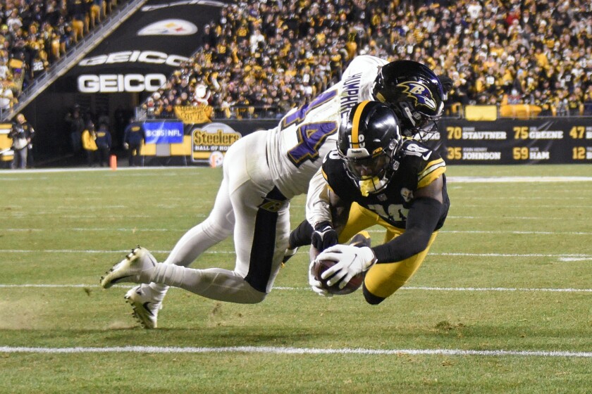 Pittsburgh Steelers wide receiver Diontae Johnson (18) gets to the end zone after making a catch past Baltimore Ravens cornerback Marlon Humphrey (44) during the second half of an NFL football game, Sunday, Dec. 5, 2021, in Pittsburgh. The Steelers won 20-19. (AP Photo/Don Wright)