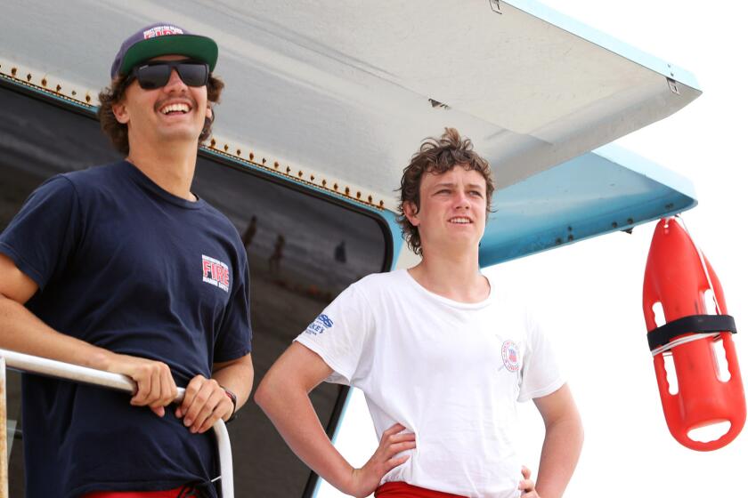 Huntington Beach Lifeguard Sam Smith, left, and Illinois Cooney a Junior Lifeguard