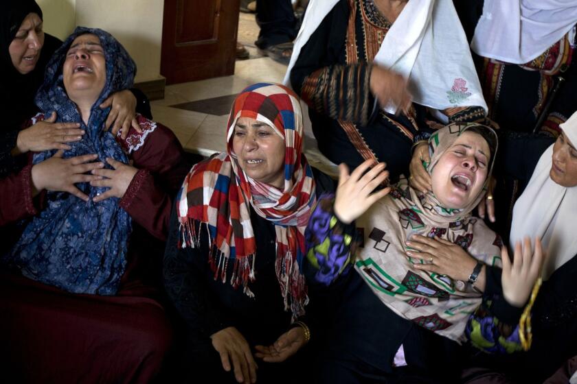 Palestinian women grieve following the deaths of several people in an Israeli air strike on a home in the north of the Gaza Strip early Wednesday.