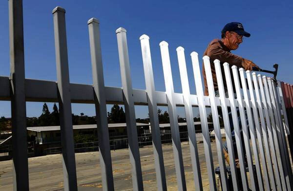 Vahe Takhman works on the fence surrounding Monterey Highlands Elementary School in Monterey Park.