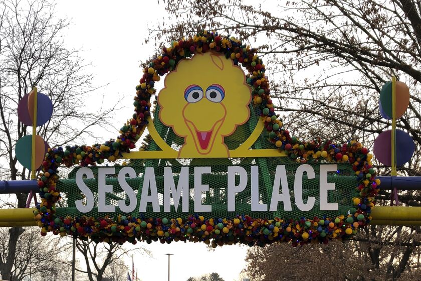 A decorated sign that says Sesame Place