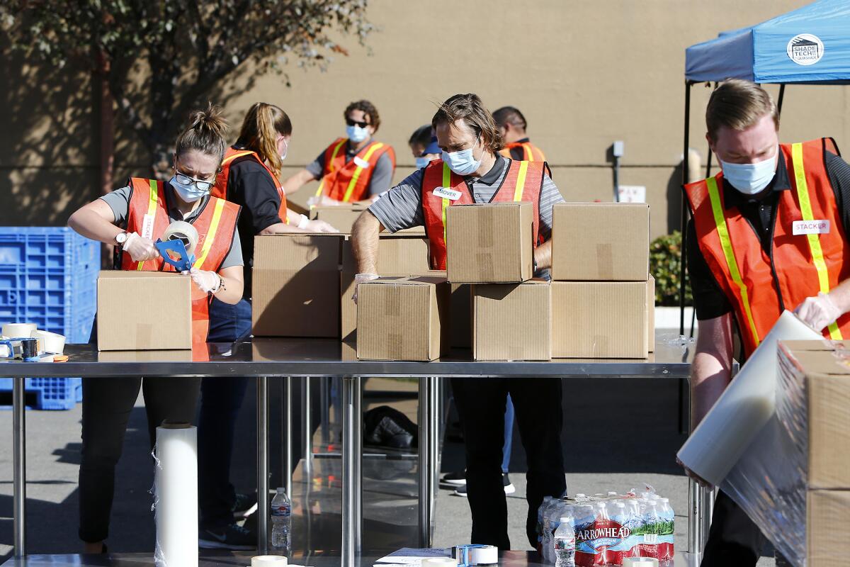 Volunteers package boxed Thanksgiving meals 