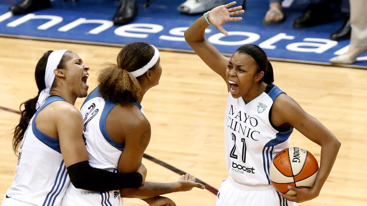 Minnesota Lynx players (from left) Maya Moore, Rebekkah Brunson and Renee Montgomery celebrate during their Game 5 victory over the Indiana Fever on Wednesday night.