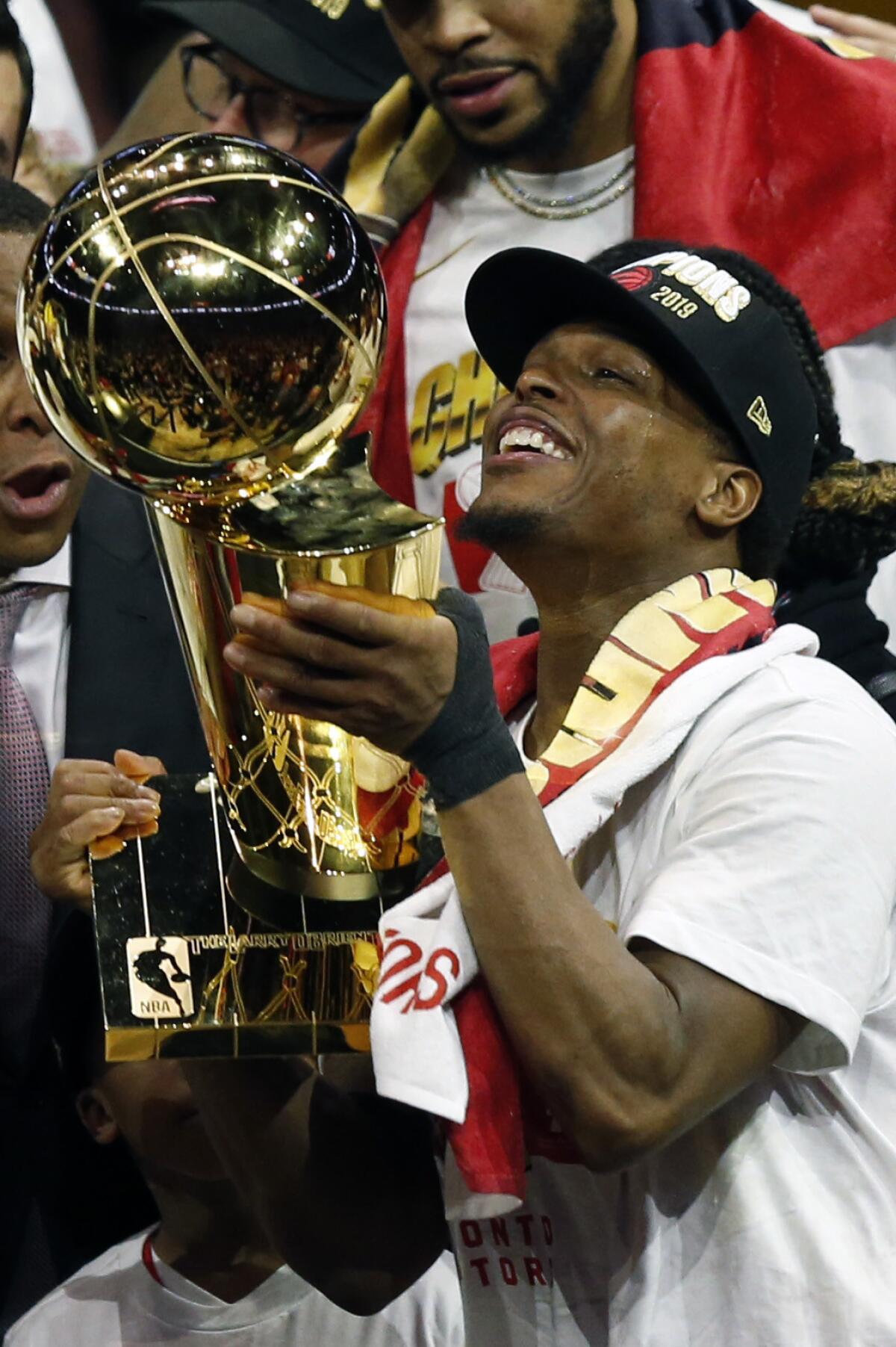Kyle Lowry #7of the Toronto Raptors celebrates with the Larry O'Brien Championship Trophy after his team defeated the Golden State Warriors.