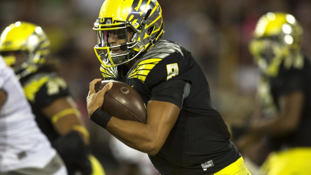 Oregon quarterback Marcus Mariota carries the ball during a win over Washington State on Sept. 20.