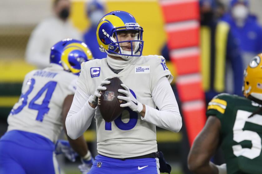 Los Angeles Rams quarterback Jared Goff (16) waits to pass during the first half of an NFL divisional playoff.