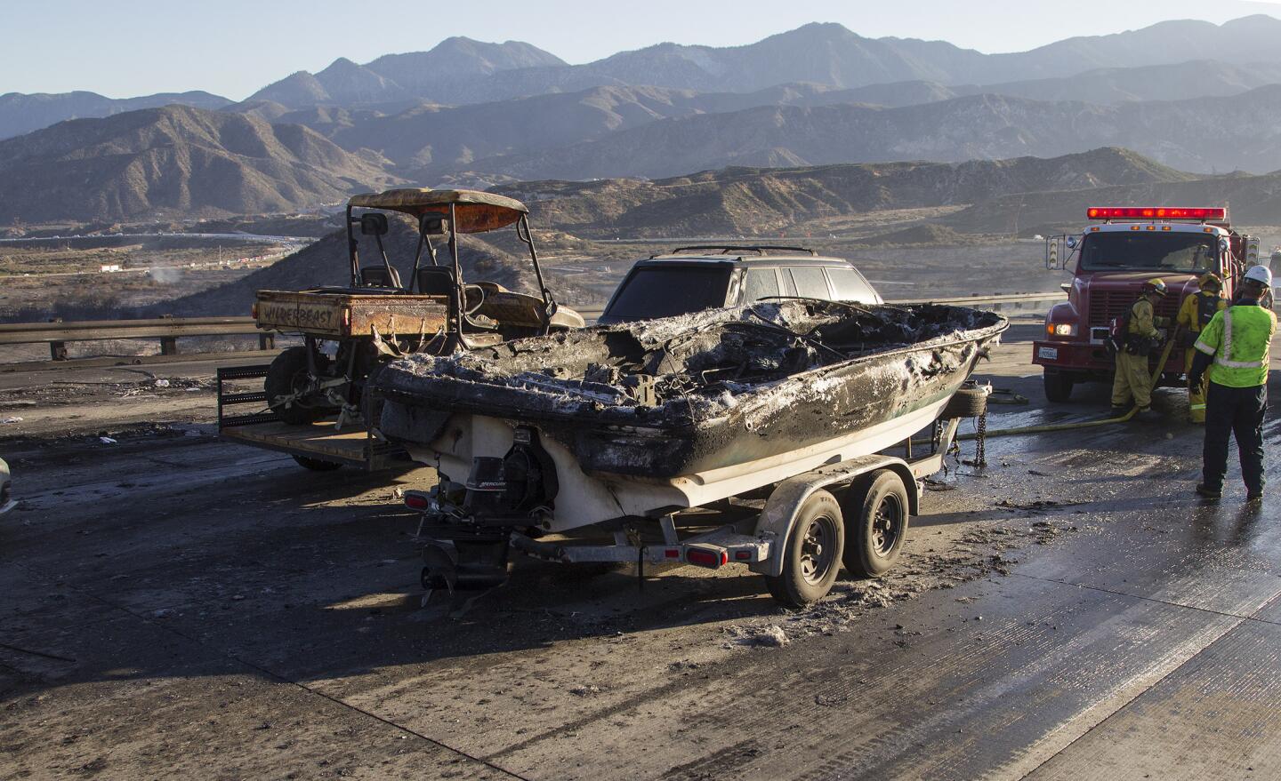 A burned boat sits on southbound Interstate 15 on July 17, 2015, in the Cajon Pass in California.