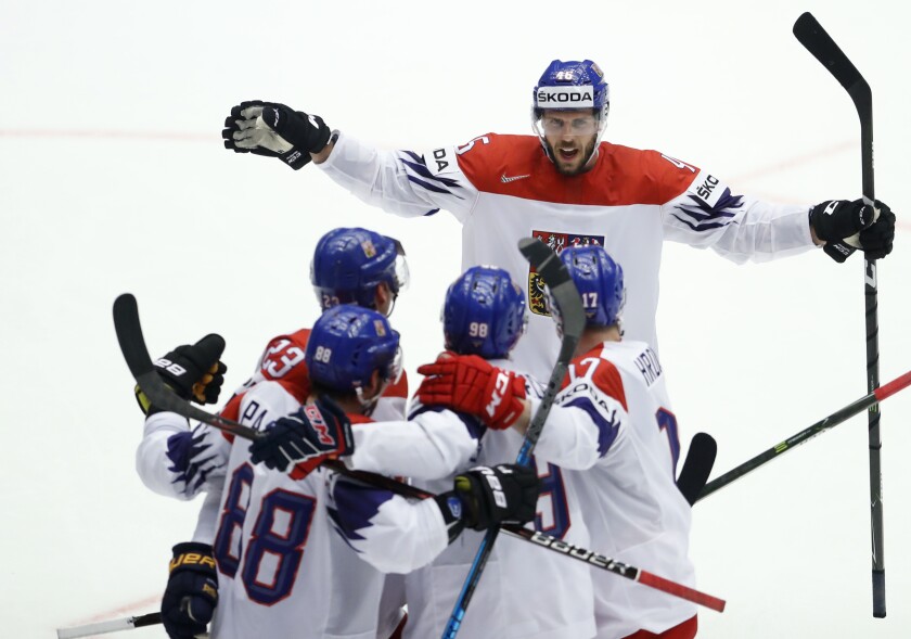 FILE- Czech Republic's David Krejci, back, and teammates celebrate a goal during the Ice Hockey World Championships quarterfinal match between the United States and Czech Republic at the Jyske Bank Boxen arena in Herning, Denmark, Thursday, May 17, 2018. On Friday Jan. 21, 2022, the Czech Republic's ice hockey team's coach Filip Pesan told reporters six of the 12 players who came from Russia's based KHL tested positive for the coronavirus ahead of the Beijing Olympics. (AP Photo/Petr David Josek, File)