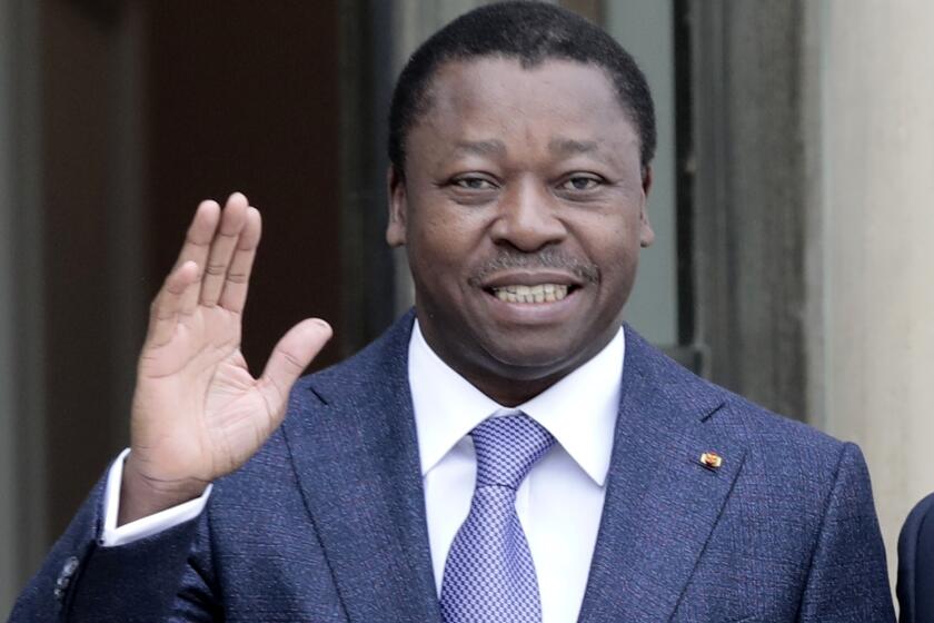 FILE - Togo's President Faure Gnassingbe waves before a working lunch at the Elysee Palace in Paris on April 9, 2021. Togolese President Faure Gnassingbe has signed a controversial new constitution that eliminates presidential elections, a statement from his office said late Monday, April 6, 2024. It's a move that opponents say will allow him to extend his family's six-decade-long rule. (AP Photo/Lewis Joly, File)