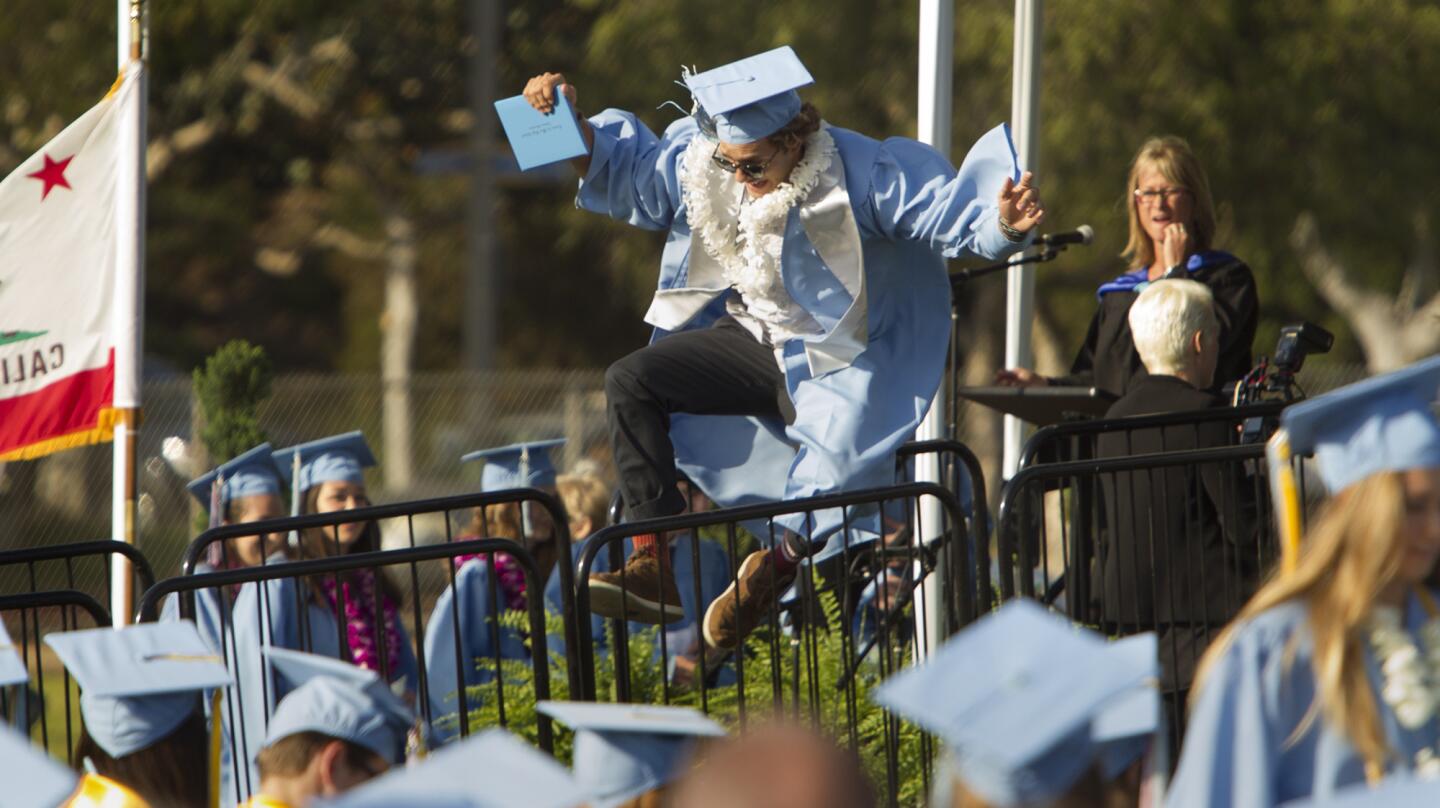 A senior celebrates after getting his diploma during Corona del Mar High School's Class of 2017 commencement ceremony on Thursday in Newport Beach.