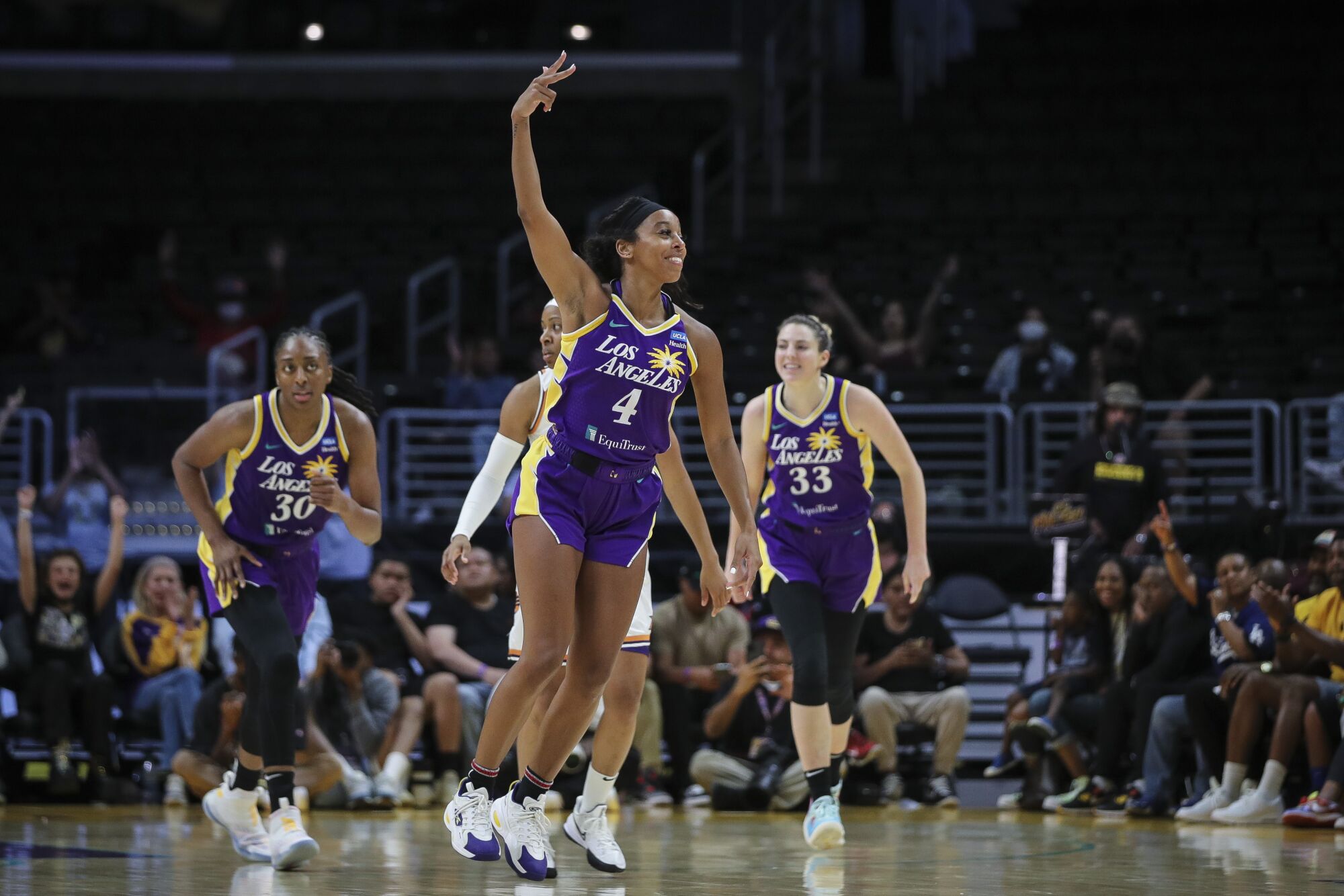 Sparks' Lexie Brown reacts after scoring a three-point basket against the Phoenix Mercury.