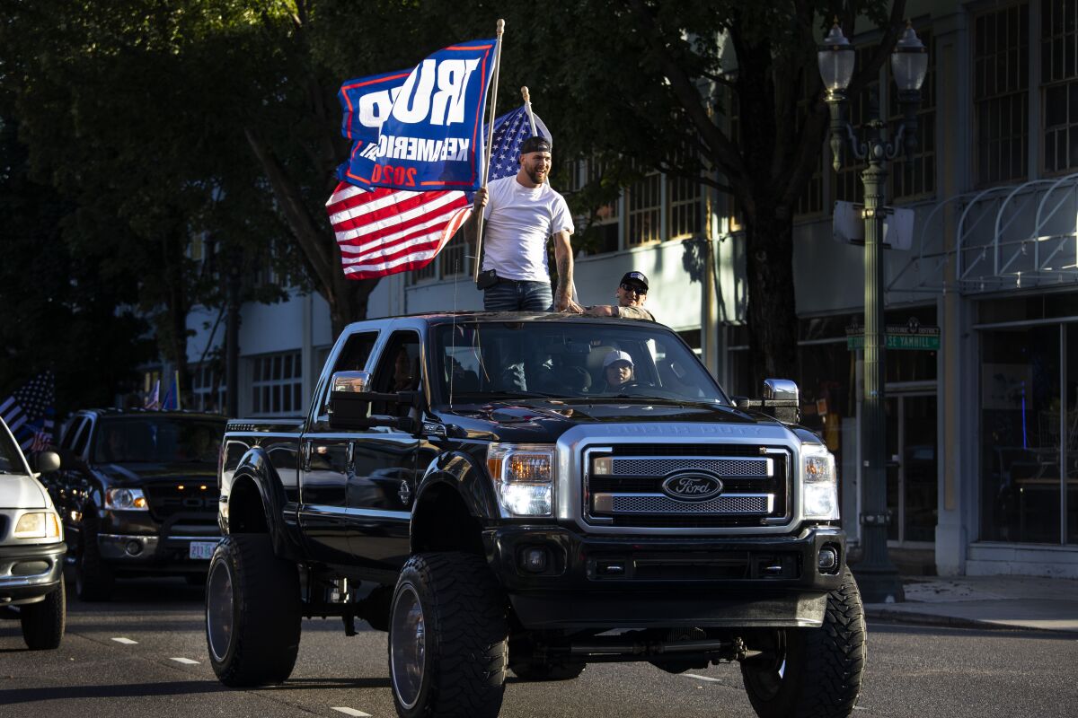 Supporters of President Trump attend a rally and car parade Saturday from Clackamas to Portland, Ore.