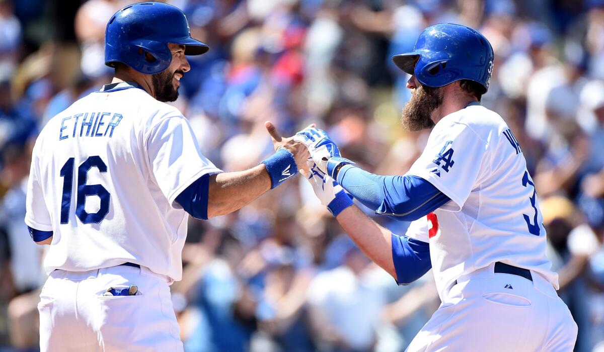 Dodgers left fielder Scott Van Slyke is congratulated by left fielder Andre Ethier after hitting a two-run home run against the Rockies in the sixth inning Sunday.