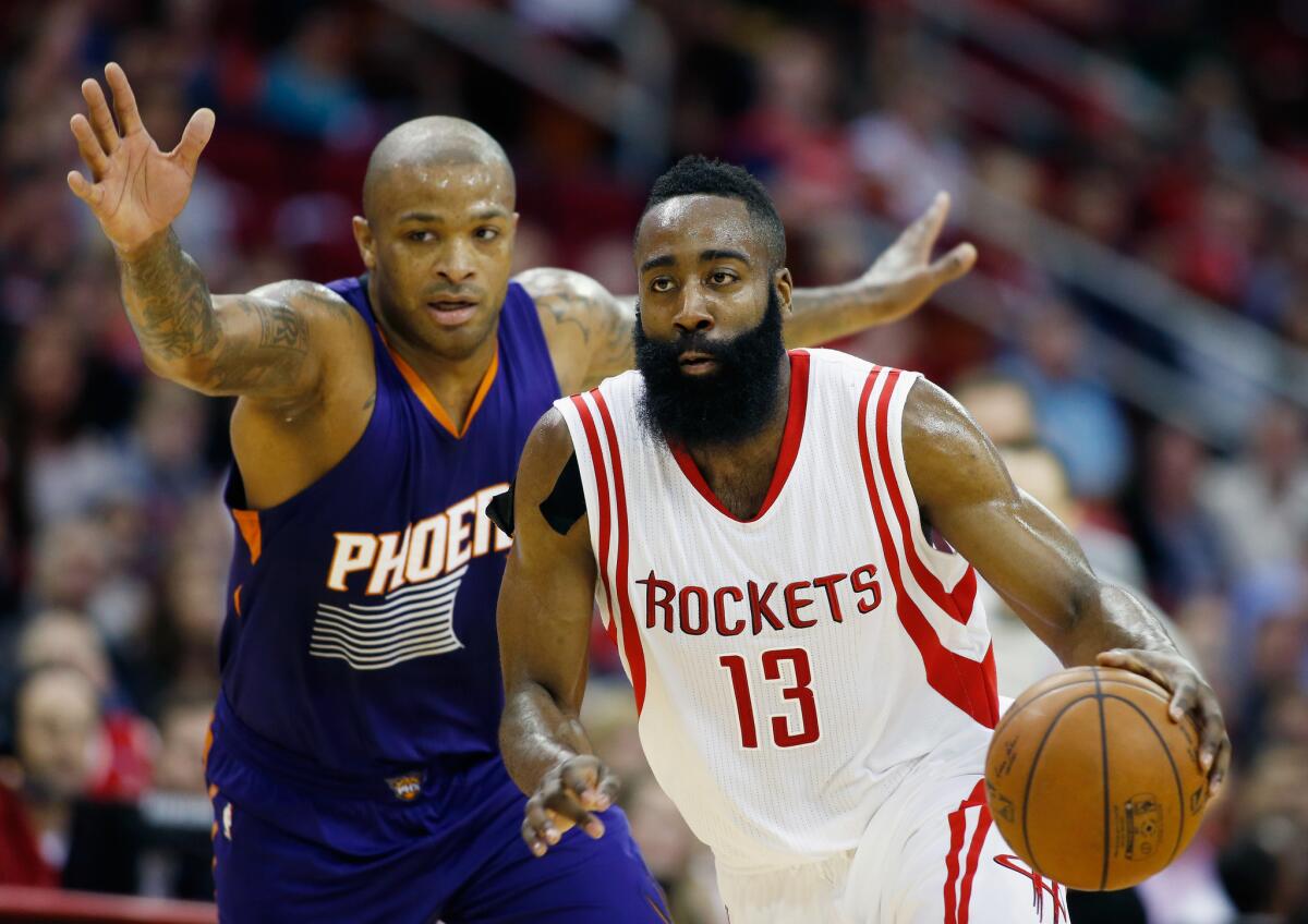 Houston's James Harden drives in front of Phoenix's P.J. Tucker.