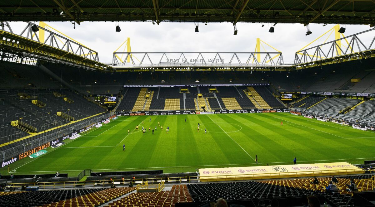 Empty seats are seen in the Signal Iduna Park without spectators  during the German Bundesliga soccer match between Borussia Dortmund and Schalke 04 in Dortmund, Germany on Sautrday.