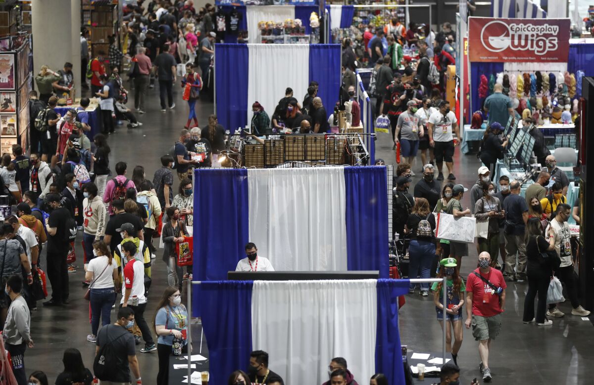  People walk through Comic-Con Special Edition at the San Diego Convention Center on Nov. 27.