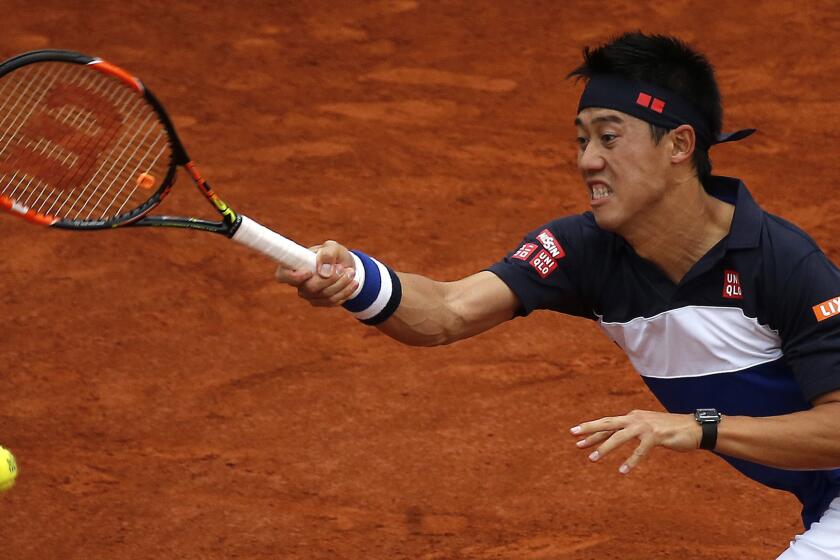 Kei Nishikori hits a return during his victory over Teymuraz Gabashvili in the fourth round of the French Open on May 31, 2015.