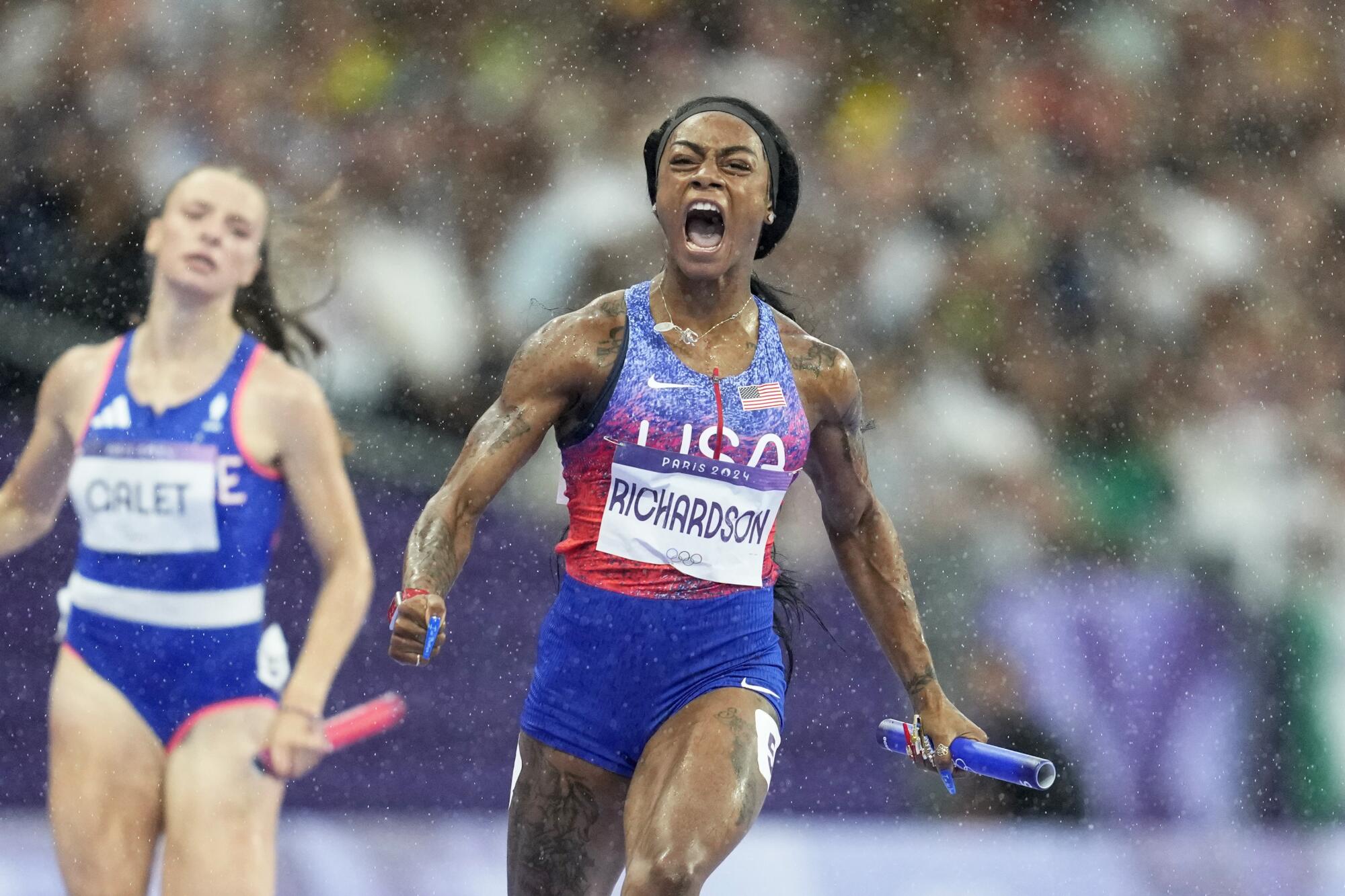 American Sha'carri Richardson cheers as she crosses the finish line to win the women's 4x100-meter relay final