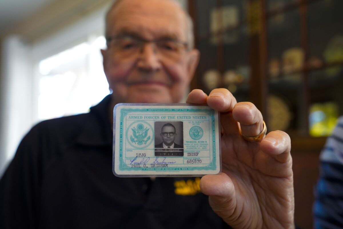 Retired Navy Lt. Paul Grisham of San Carlos shows the military ID he lost with his wallet in 1968 in Antarctica.