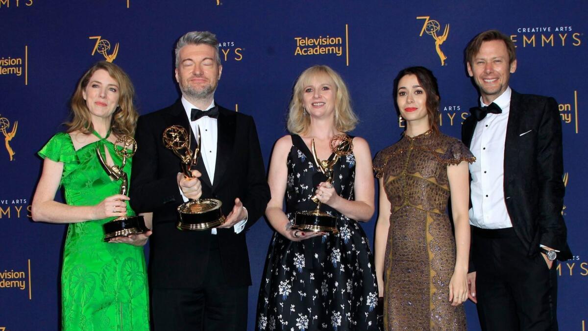 The team behind "Black Mirror: USS Callister" hold their Emmys backstage. The Netflix drama won three awards Saturday.