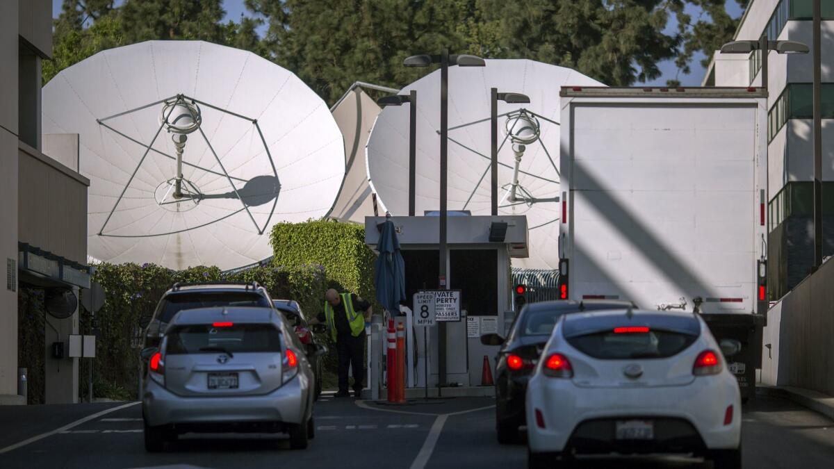 Satellite dishes are seen near a gate to Fox Studios in Century City.